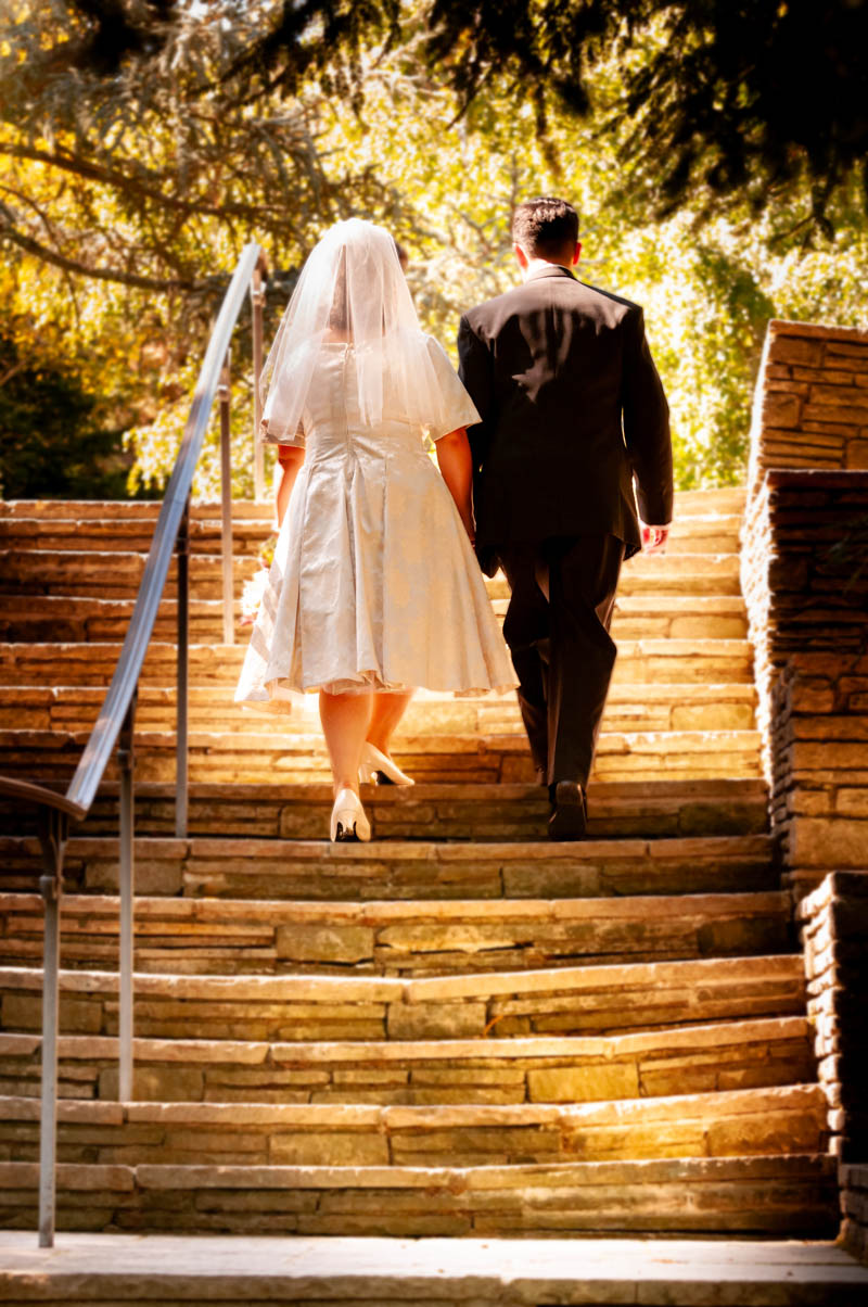 Bride and Groom Walking up Stairs at Hacienca