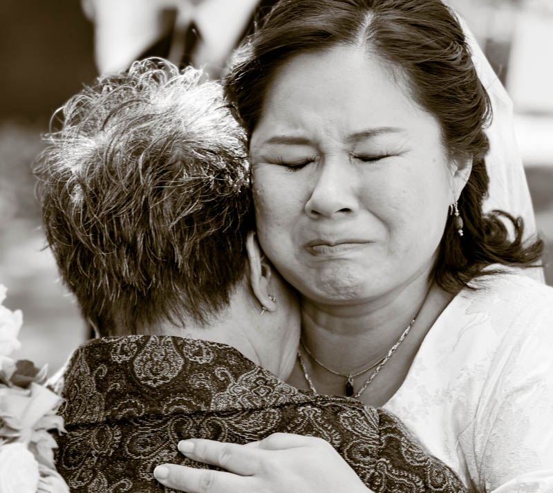 Bride tearfully hugs mother after ceremony